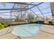 Kidney-shaped pool with screened enclosure at 3103 Royal Palm Dr, Edgewater, FL 32141