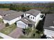 Aerial view of a house with gray roof and paver driveway in a neighborhood at 3133 Crab Trap Dr, New Smyrna Beach, FL 32168