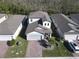 Aerial view showcasing a house with gray roof and paver driveway at 3133 Crab Trap Dr, New Smyrna Beach, FL 32168