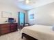 Bright bedroom with large bed, dresser, and TV at 3133 Crab Trap Dr, New Smyrna Beach, FL 32168