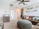 Bonus room with sectional sofa, built-in shelving, and adjacent hallway at 3133 Crab Trap Dr, New Smyrna Beach, FL 32168