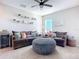 Bright bonus room featuring sectional sofa, shelving, and cozy atmosphere at 3133 Crab Trap Dr, New Smyrna Beach, FL 32168