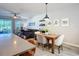 Kitchen dining area with wooden table and chairs, and view into living room at 3133 Crab Trap Dr, New Smyrna Beach, FL 32168