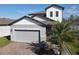 Two-story house with gray siding, gray roof, and a brick paver driveway at 3133 Crab Trap Dr, New Smyrna Beach, FL 32168