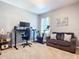 Home office features a standing desk, exercise bike, and comfortable couch at 3133 Crab Trap Dr, New Smyrna Beach, FL 32168