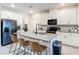 Modern kitchen with white cabinets, granite countertops, and island with seating at 3133 Crab Trap Dr, New Smyrna Beach, FL 32168