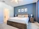 Main bedroom with king bed, nightstands, and large window at 3133 Crab Trap Dr, New Smyrna Beach, FL 32168