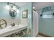 Charming bathroom with light teal walls, white sink, and beachy decor at 321 Jessamine Ave, New Smyrna Beach, FL 32169