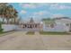 A charming two-story beach cottage with a white picket fence and a spacious yard at 321 Jessamine Ave, New Smyrna Beach, FL 32169