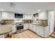 Well-equipped kitchen with white cabinets and a gas stove at 321 Jessamine Ave, New Smyrna Beach, FL 32169