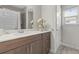 Modern bathroom with brown vanity, white countertop, and a shower at 3309 Modena Way, New Smyrna Beach, FL 32168