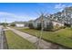 House exterior, showcasing a gray facade and neatly manicured lawn at 3309 Modena Way, New Smyrna Beach, FL 32168