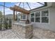 Enjoy this outdoor kitchen with a stone facade and built-in grill at 3309 Modena Way, New Smyrna Beach, FL 32168