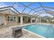 Resort-style pool with outdoor kitchen, covered patio, and fire pit at 3309 Modena Way, New Smyrna Beach, FL 32168