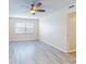 Bedroom with ceiling fan, window, and hardwood floors at 3800 Saxon Dr # 39039C, New Smyrna Beach, FL 32169