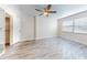 Bright bedroom with ceiling fan and wood-look floors at 3800 Saxon Dr # 39039C, New Smyrna Beach, FL 32169