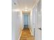 Light and bright hallway with wood-look flooring at 3800 Saxon Dr # 39039C, New Smyrna Beach, FL 32169