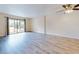 Spacious living area with wood-look flooring and sliding doors at 3800 Saxon Dr # 39039C, New Smyrna Beach, FL 32169