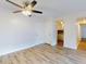 Bright living room with light walls, wood-look floors, and ceiling fan at 3800 Saxon Dr # 39039C, New Smyrna Beach, FL 32169