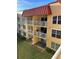 Two-story building with balconies and lush green lawn at 3801 S Atlantic Ave # 304, New Smyrna Beach, FL 32169