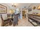 Condo dining area featuring a glass-top table and wicker chairs at 3801 S Atlantic Ave # 304, New Smyrna Beach, FL 32169