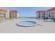 Inviting pool area with a hot tub, lounge chairs, and ocean views at 3801 S Atlantic Ave # 304, New Smyrna Beach, FL 32169