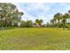 Large grassy backyard with mature trees and a fenced area at 388 N Glencoe Rd, New Smyrna Beach, FL 32168