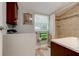 This bathroom features a shower with tan tile, a window, and a wood vanity at 388 N Glencoe Rd, New Smyrna Beach, FL 32168