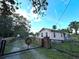 Pink house with a black metal gate and a spacious yard at 388 N Glencoe Rd, New Smyrna Beach, FL 32168