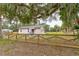 Charming single-story home featuring a quaint fence, and lush landscaping at 388 N Glencoe Rd, New Smyrna Beach, FL 32168