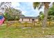 Charming single-story home featuring a quaint fence, and lush landscaping at 388 N Glencoe Rd, New Smyrna Beach, FL 32168