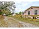 Exterior view of property featuring a quaint fence, side yard, and driveway at 388 N Glencoe Rd, New Smyrna Beach, FL 32168