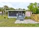 Charming screened front porch with gray wood stairs and stone tile leading up to the entrance at 388 N Glencoe Rd, New Smyrna Beach, FL 32168