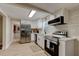 Bright kitchen with stainless steel appliances, white cabinetry, and a convenient breakfast bar at 388 N Glencoe Rd, New Smyrna Beach, FL 32168