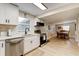 Open concept kitchen with stainless appliances, white cabinets, and view to dining area at 388 N Glencoe Rd, New Smyrna Beach, FL 32168