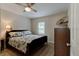 Comfortable bedroom featuring a ceiling fan, dark wood bed frame, and patterned bedding at 388 N Glencoe Rd, New Smyrna Beach, FL 32168