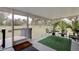 Relaxing screened porch with outdoor seating and lush greenery at 388 N Glencoe Rd, New Smyrna Beach, FL 32168