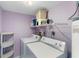 Bright laundry room with shelving and full-size appliances at 4139 S Atlantic Ave # A307, New Smyrna Beach, FL 32169