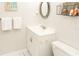 Bathroom with white vanity, toilet and beach themed decor at 4155 S Atlantic Ave # 111, New Smyrna Beach, FL 32169