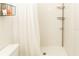 Clean bathroom with shower, toilet, and white tile at 4155 S Atlantic Ave # 111, New Smyrna Beach, FL 32169