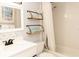 Bathroom with white vanity, bathtub, and decorative shelves at 4155 S Atlantic Ave # 111, New Smyrna Beach, FL 32169