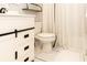 Bathroom featuring white vanity with black accents and toilet at 4155 S Atlantic Ave # 111, New Smyrna Beach, FL 32169