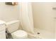 Clean bathroom with shower, toilet and white tile at 4155 S Atlantic Ave # 111, New Smyrna Beach, FL 32169