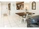 Dining area with farmhouse table and white chairs at 4155 S Atlantic Ave # 111, New Smyrna Beach, FL 32169