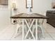 Dining area with farmhouse table and white chairs at 4155 S Atlantic Ave # 111, New Smyrna Beach, FL 32169