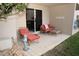 Private patio with lounge chairs and small table at 4155 S Atlantic Ave # 111, New Smyrna Beach, FL 32169