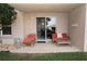 Private patio with lounge chairs and small table at 4155 S Atlantic Ave # 111, New Smyrna Beach, FL 32169