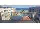 Oceanfront balcony view with patio table, pool, and partial ocean view at 4155 S Atlantic Ave # 5090, New Smyrna Beach, FL 32169