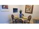 Small dining area with glass-top table and four chairs at 4155 S Atlantic Ave # 5090, New Smyrna Beach, FL 32169