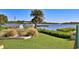 Landscaped backyard with a view of the calm water at 417 N Riverside Dr, Edgewater, FL 32132